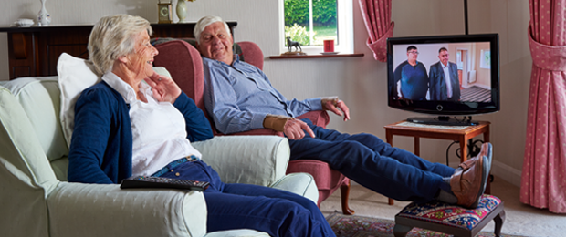Two people aged over 75 watching television
