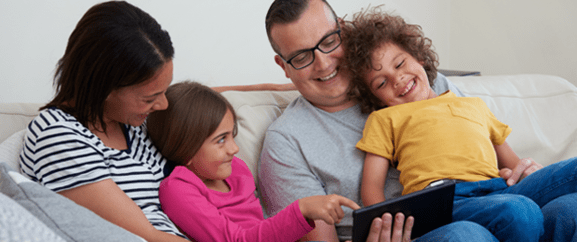 Family looking at a tablet device